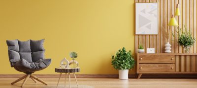 Modern Interior wall mockup with armchair on empty yellow wall.